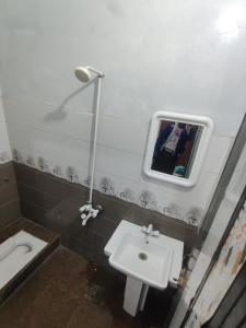 a bathroom with a sink and a toilet at Al Hidayah Hotel Multan in Multan