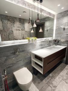 a bathroom with a sink and a toilet and a mirror at Sandy's Superior Suite in Ancient Epidauros +37 photos