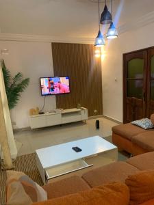 a living room with a couch and a tv at Dalal Diam in Dakar