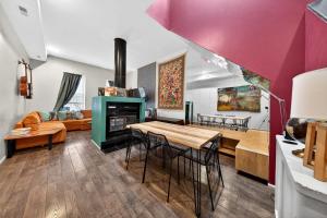 a kitchen and living room with a table and a fireplace at Stylish STL Gem ABODEbucks in Saint Louis