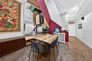 a dining room with a large painting on the wall at Stylish STL Gem ABODEbucks in Saint Louis