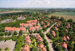 an aerial view of a suburb with red roofs at Strand Hotel Deichläufer in Butjadingen