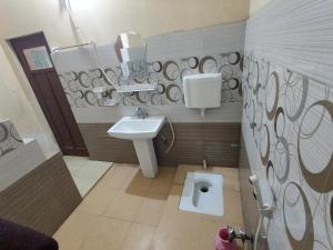 a bathroom with a sink and a toilet at Al Hidayah Hotel Multan in Multan