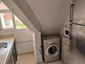 a small kitchen with a washer and a refrigerator at Dar Yasmine 2 in Ifrane