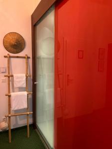a bathroom with a red door and a towel rack at Pension Stadthalle in Vienna +85 photos