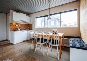 a kitchen and dining room with a table and chairs at Bla Hus B&B in Reykjavík