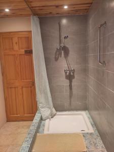 a shower with a white tub in a bathroom at Chez Marie Roulotte in Pontfarcy +32 photos