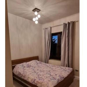a bedroom with a bed and a window at Cosy studio in Bucharest