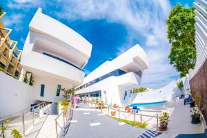 a view of the exterior of a white building at Ancla Real Apartamentos Loft in El Puerto de Santa María