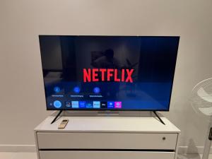 a flat screen tv sitting on top of a dresser at Modus Pattaya Beachfront Apartment in North Pattaya