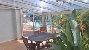 a patio with a table and chairs and a pool at Gite d'Ossau in Lescar