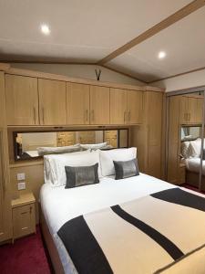 a bedroom with a large bed with two pillows at Seven Bays Hideaway in Saint Merryn