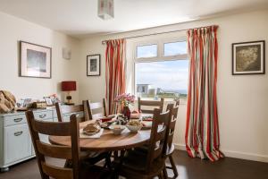 a dining room with a table and a window at Self-catering Lighthouse Keeper's Cottage on the NC500 in Wick