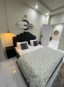 a bedroom with a large bed in a room at Riverhills Comfort 2BHK in Rawalpindi