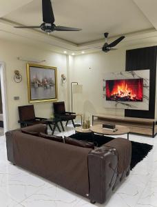 a living room with a couch and a fireplace at Riverhills Comfort 2BHK in Rawalpindi