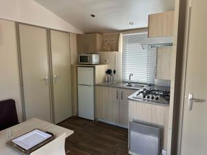 a small kitchen with a sink and a stove at Camping Rio Vero de Alquézar in Alquézar +12 photos