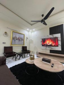 a living room with a couch and a fireplace at Riverhills Comfort 2BHK in Rawalpindi