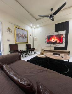 a living room with a bed and a fireplace at Riverhills Comfort 2BHK in Rawalpindi +10 photos