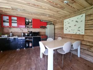 a kitchen with a table and chairs in a room at Oandu Camping saunamaja in Oandu