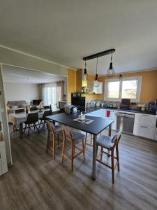 a kitchen and dining room with a table and chairs at L'Oustal in Saint-Constant