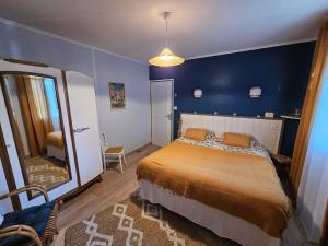a bedroom with a large bed and a mirror at L'Oustal in Saint-Constant
