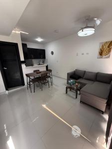 a living room with a couch and a table at Moon Apartamentos D3 in San Cristóbal