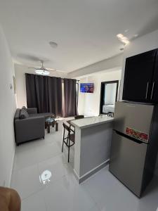 a kitchen and living room with a refrigerator and a couch at Moon Apartamentos D3 in San Cristóbal