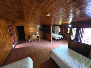 a bedroom with a bed and a desk in a room at Auberge RAMZ'S in Beni Mellal