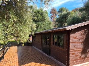 a small wooden building with a brick patio at Auberge RAMZ'S in Beni Mellal