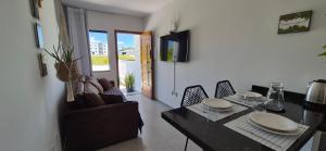a living room with a dining room table and chairs at Casa42 aconchego perto de Florianópolis in Palhoça +38 photos