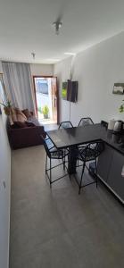 a living room with a table and chairs and a couch at Casa42 aconchego perto de Florianópolis in Palhoça