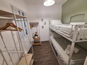 a small room with two bunk beds and a staircase at Casa Milda in Sanremo