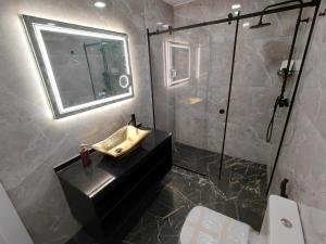 a bathroom with a shower and a sink and a mirror at Estalagem De Colares in Sintra