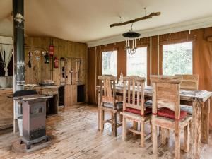 a dining room with a wooden table and chairs at 6-person Duynlodge Tent in Callanstoog in Callantsoog