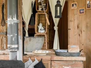 a room with wooden walls and a counter with a sink at 6-person Duynlodge Tent in Callanstoog in Callantsoog