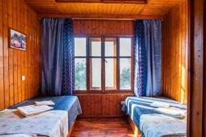 two beds in a room with a window at Barbarossa Apartments in Vrachonisída Prasonísi +94 photos