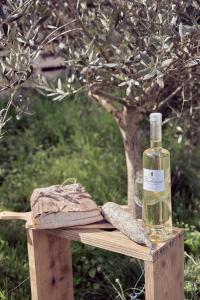 a bottle of wine and a loaf of bread on a table at La ferme in Moltifao