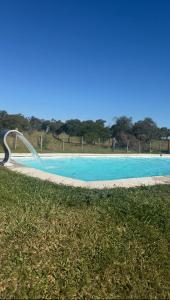 a pool with a water slide in the grass at Posada San José de Lucas in Tupambaé