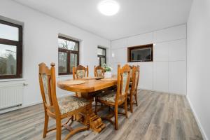 a dining room with a wooden table and chairs at Apartmán Regina in Liberec +12 photos