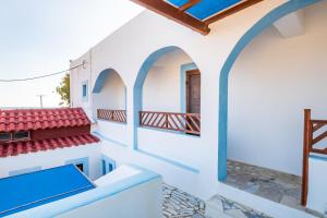 a view from the balcony of a house with a red roof at Barbarossa Apartments in Vrachonisída Prasonísi