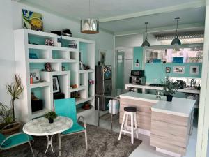 a kitchen with blue walls and a table and chairs at 2nd floor loft with swimming pool in Oaxaca City
