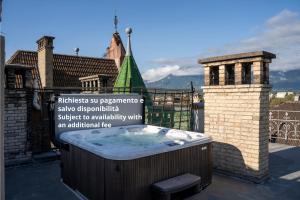 a hot tub on the roof of a building at Talvera Dream - City center, Rooftop, Garage & Jacuzzi in Bolzano