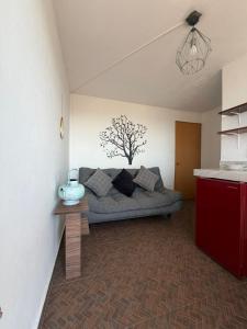 ein Wohnzimmer mit einer Couch in der Ecke eines Zimmers in der Unterkunft Apartamento 32 in Toluca de Lerdo