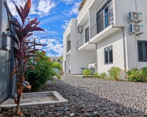 a plant in front of a building at Label résidence 2 in Grand-Baie