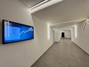 a hallway with a flat screen tv on the wall at GG Apartment 8 in Garmisch-Partenkirchen