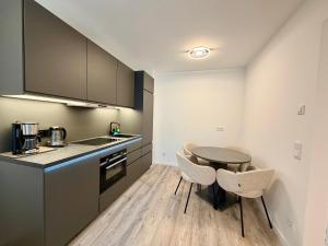 a kitchen with a table and chairs in a room at GG Apartment 8 in Garmisch-Partenkirchen