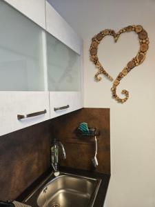 a kitchen with a heart on the wall next to a sink at MountainLOVE in Strobl