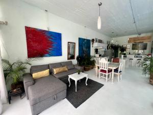 a living room with a couch and a table at fascinating loft with swimming pool in Oaxaca City