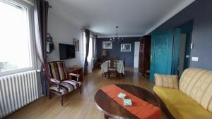a living room with a couch and a table at Chez Uber in Niort