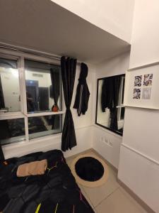 a bedroom with a bed and two windows at Ajman Central Downtown B-50018 in Ajman 